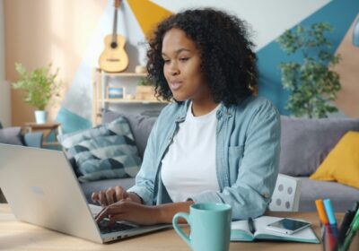 Alleinerziehende arbeitet am Laptop von zu Hause